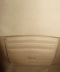 Close-up of a vanilla clutch leather bag with cards compartment