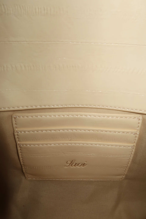 Close-up of a vanilla clutch leather bag with cards compartment
