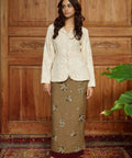 Woman in a beige beaded top and skirt for raya 2026