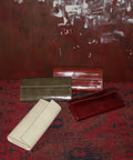 Four clutch in different colors with a vintage textured leather material