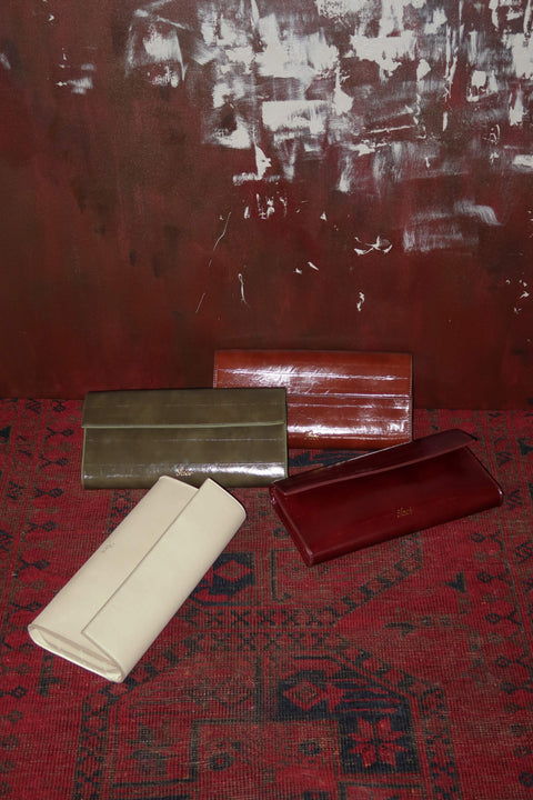 Four clutch in different colors with a vintage textured leather material