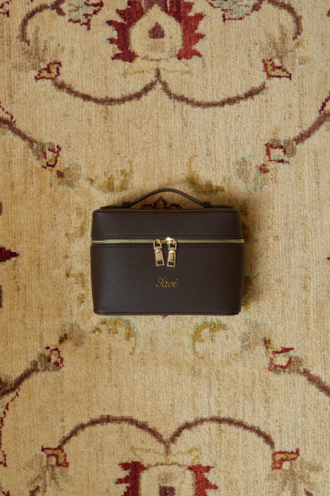 dark brown handbag with gold accents with straps