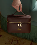 Brown travel case with gold accents